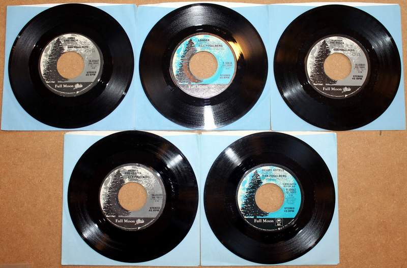 Lot of 5 Dan Fogelberg 45's in Original Sleeves Produced by Full Moon / Epic.  Titles on this side from top left to lower right: Times Like These 1980; Longer 1979; Run for the Roses 1981; Hearts and Crafts 1980; Demo Record - Heart Hotels