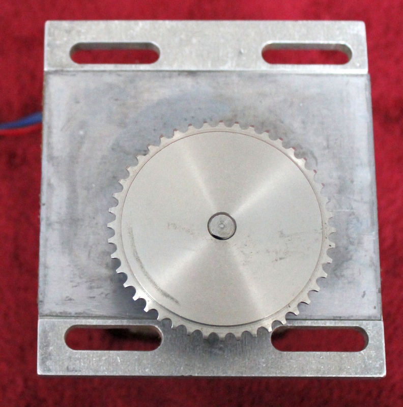 Hurst Mfg. Synchronous AC Gear Motor Model T P/N SP-2289 mounted on aluminum bracket with sprocket attached. 10 RPM