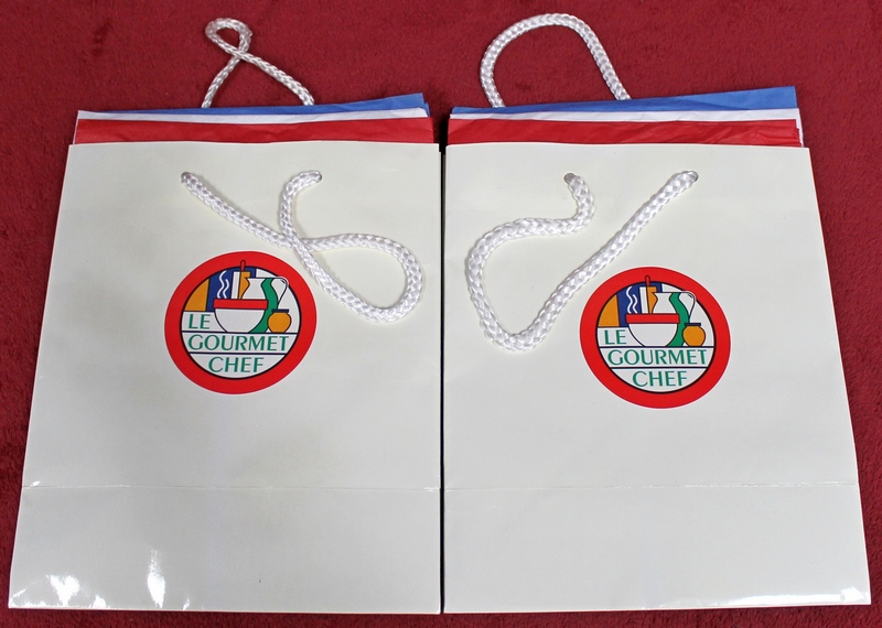 2 Le Gourmet Chef Gift Bags with gift wrap tissue inside